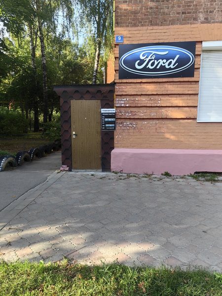 Вход в магазин запчастей Ford ГлавкАвто: дверь с номером дома 9 и режимом работы